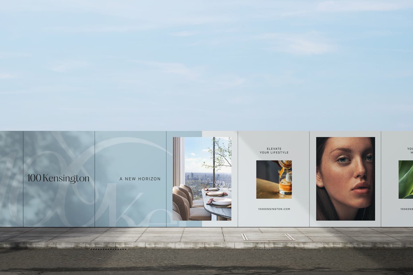 A promotional construction site hoarding displays branding for 100 Kensington, interior and exterior views, a close-up of a woman's face, and lifestyle imagery.