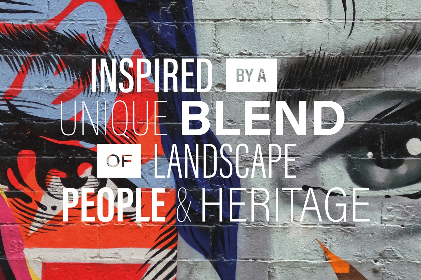 Colourful abstract mural with a close-up of a human face and bold text reading: Inspired by a unique blend of landscape, people & heritage.
