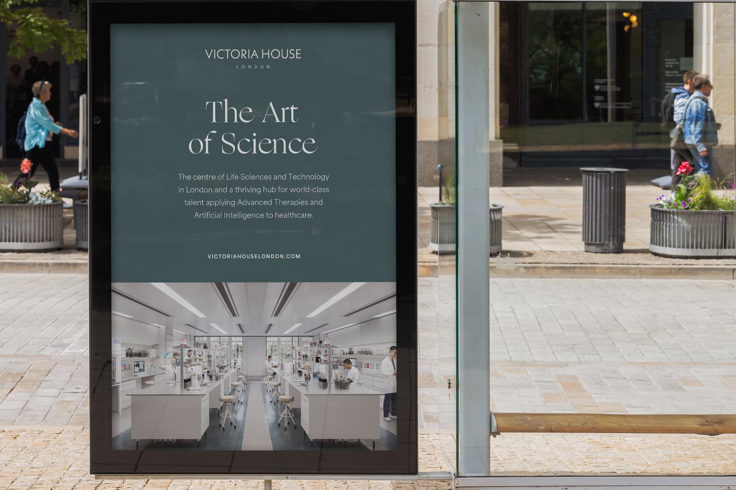A bus stop advert for Victoria House London promoting The Art of Science with text and an image of a modern laboratory interior.