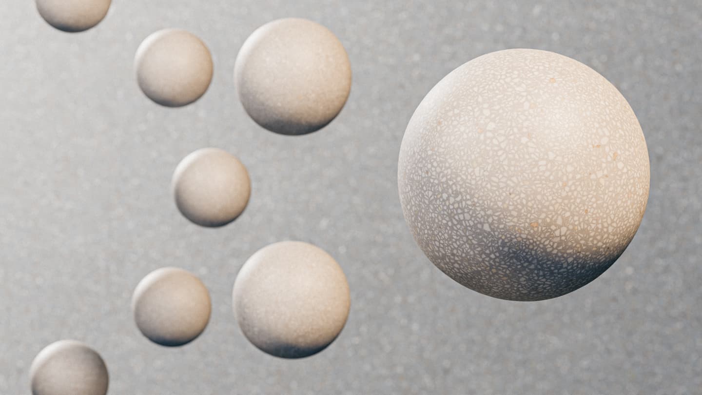 Eight textured beige spheres of varying sizes float against a grey speckled background, with one sphere in the foreground and the others receding into the distance.